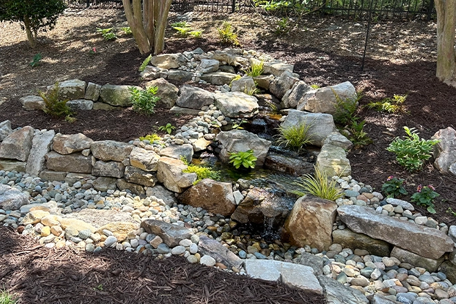 Turn your unwanted pond into a low maintenance stream like this